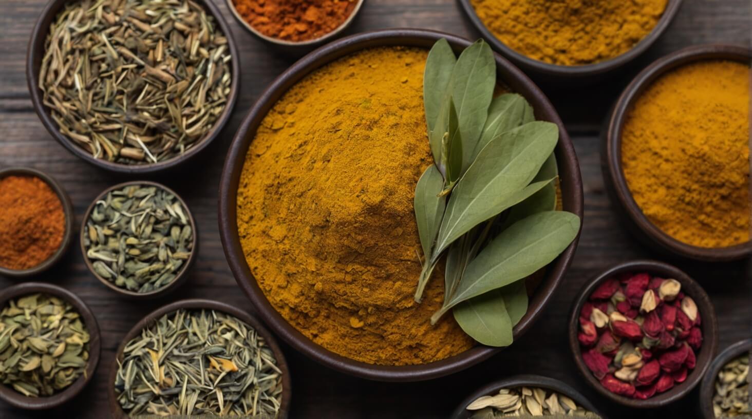 A variety of colorful herbs arranged in a vibrant display, including turmeric, ginger, and cinnamon, renowned for their potent anti-inflammatory properties.